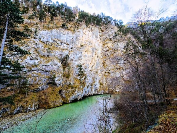 rocky alpine riverscape in winter, no snow