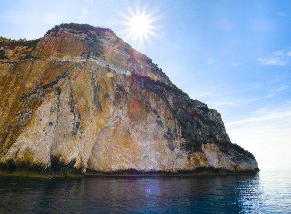 the rocky coast of the mediterranean island paxos with sunstar