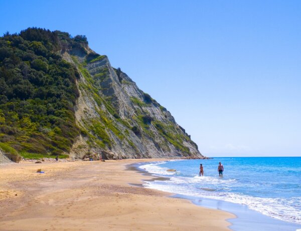 people swimming at the rocky cape asprocavos beach, corfu